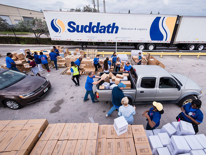suddath employees loading boxes onto vehicles