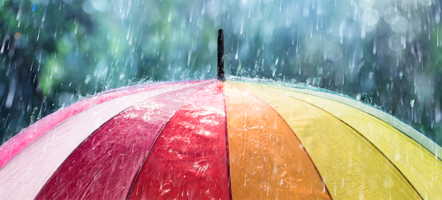 rain falling on colored umbrella